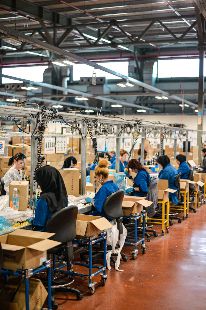Operatives working along an assembly line in a manufacturing facility