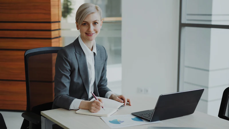 Two professional advisers reviewing client documents in an office