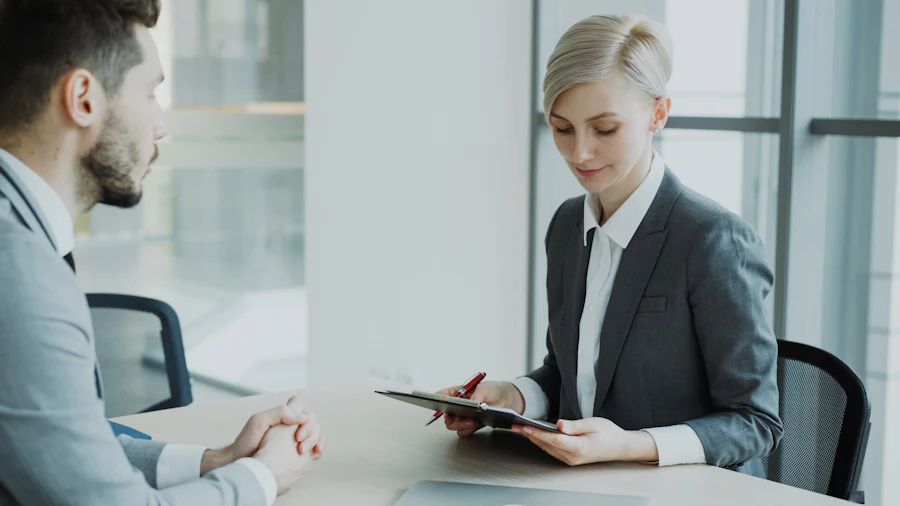 Colleagues reviewing a client document together in a meeting room