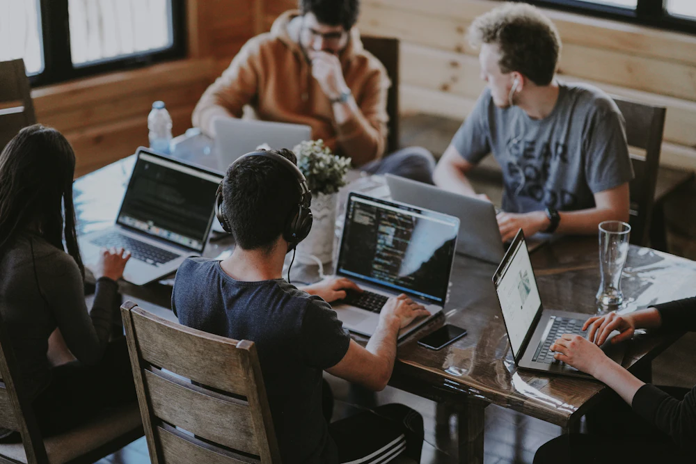 Colleagues configuring a business software platform together on a laptop